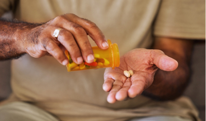elderly-hands-pouring-pills-into-palm