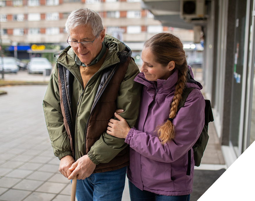 elderly-man-walking-out-of-hospital-with-daughter