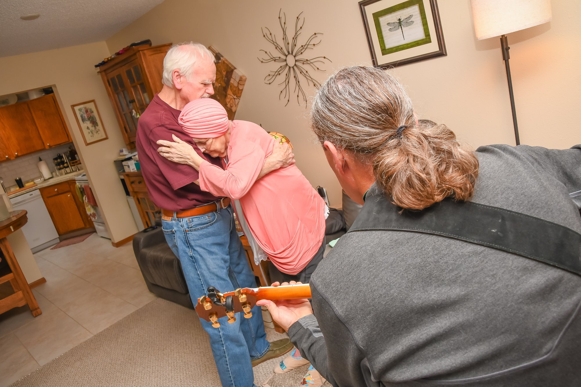 two people dancing to musician with guitar